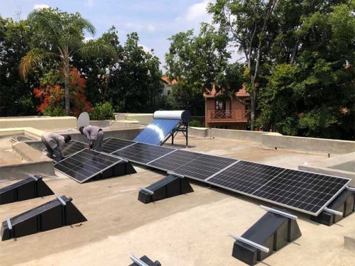 Solar Installer Mounting Solar Panels On Water Ballast